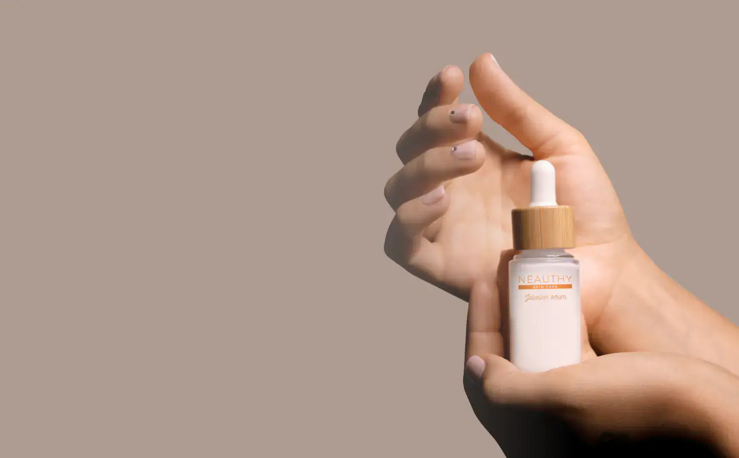 Vegan body mist in a white bottle with a wooden cap, held by hands on beige background.